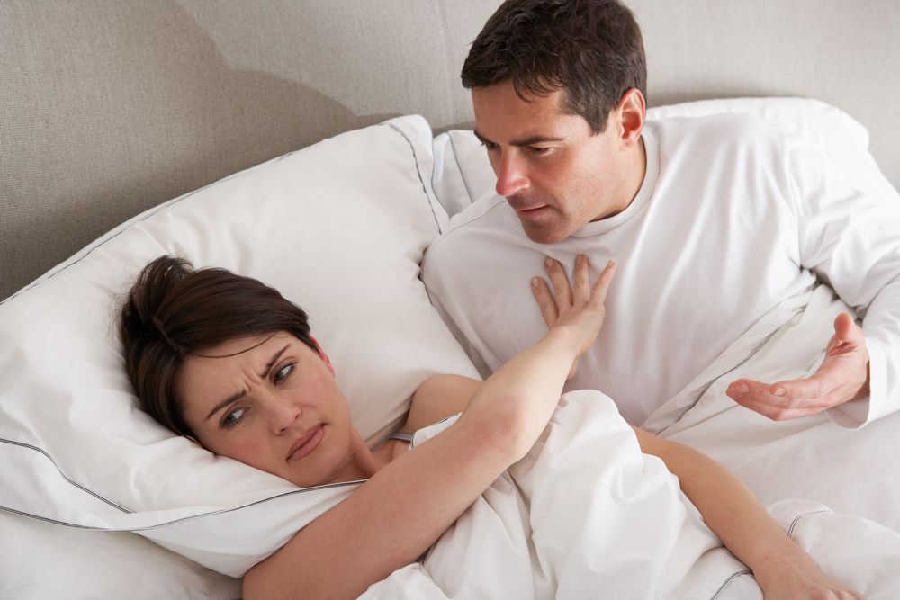 Femme repoussant un homme au lit